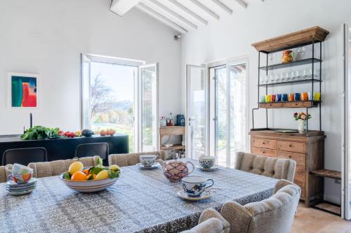 a dining room with a table with a bowl of fruit on it at CASALE ORTALI by Miani Group in Pesciano