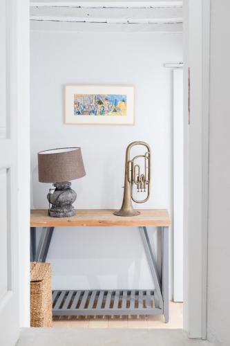 a console table with a lamp on it at CASALE ORTALI by Miani Group in Pesciano