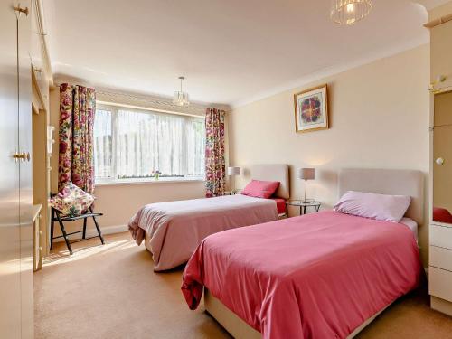 a bedroom with two beds and a window at 2 Bed in Sawmills PK934 in Whatstandwell