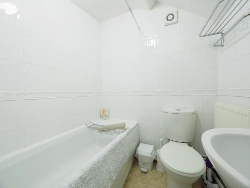 a white bathroom with a toilet and a sink at 2 Bed in Ashford in the Water PK932 in Great Longstone