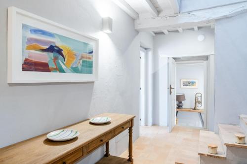 a living room with a table and a painting on the wall at CASALE ORTALI by Miani Group in Pesciano