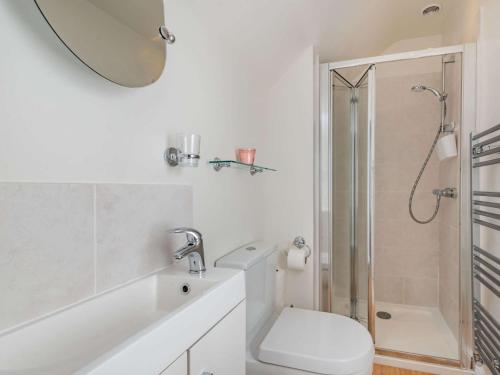 a white bathroom with a shower and a toilet at 1 Bed in Bakewell 88085 in Bakewell