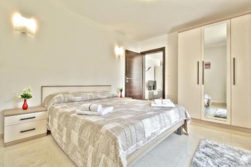 佔巴拉提拉的住宿－Villa Dolce Vita，白色的卧室设有一张大床和一间浴室。