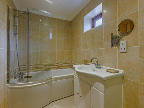 a bathroom with a sink and a tub and a shower at 2 Bed in Westward Ho 89868 in Westward Ho