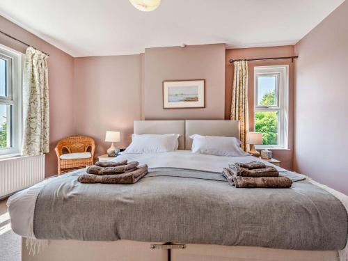 a bedroom with a large bed with towels on it at 3 Bed in Brechfa 92116 in Rhyd-cymmerau