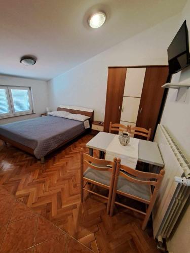 a bedroom with a bed and a table and chairs at Villa Lily in Novi Vinodolski