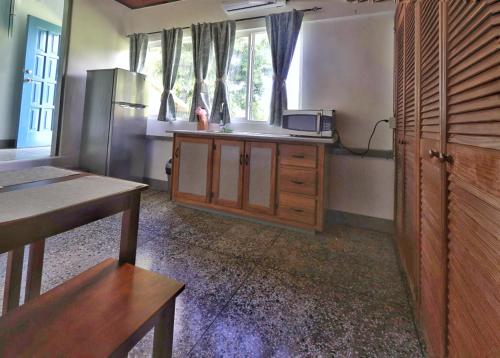 a kitchen with a stainless steel refrigerator and wooden cabinets at Cozy 1-Bed Apt in Whim Estate-near Scarborough in Scarborough