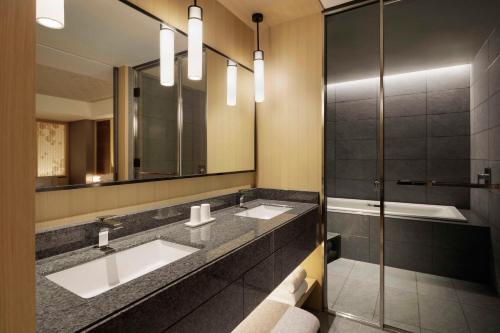 a bathroom with two sinks and a mirror at Nagoya Marriott Associa Hotel in Nagoya