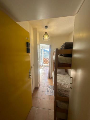 a room with a bedroom with a bunk bed and a hallway at Le shuss 4 la foux d'allos in La Foux
