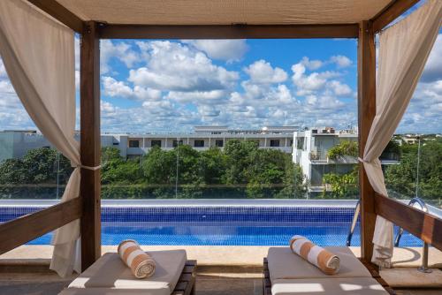 a view of a swimming pool from a hotel room window at Blue Veleta in Tulum