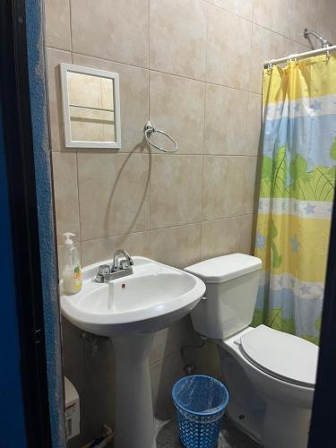 a bathroom with a sink and a toilet and a shower at Familia Sosa Suazo in San José del Cabo