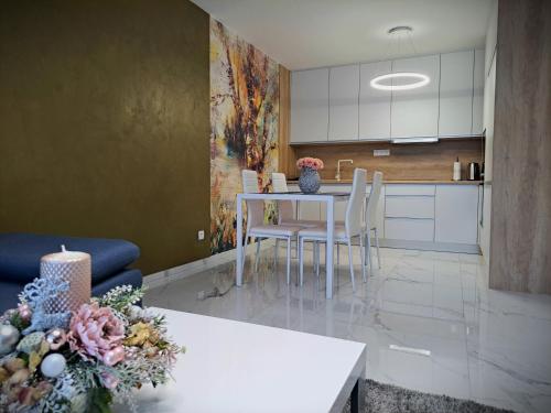 a kitchen with a table and chairs in a room at Tabáň Luxury apartment (city center & free parking) in Nitra