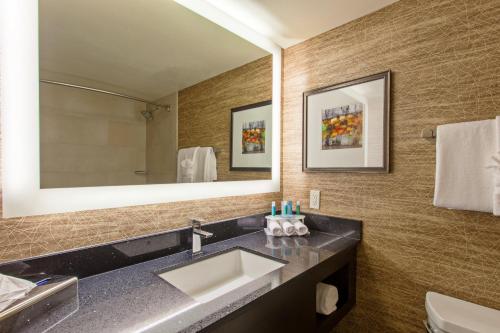 a bathroom with a sink and a mirror at Holiday Inn Express Colton, an IHG Hotel in Colton