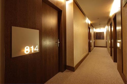 a hallway with a number sign on a wall at Olivia Plaza Hotel in Barcelona