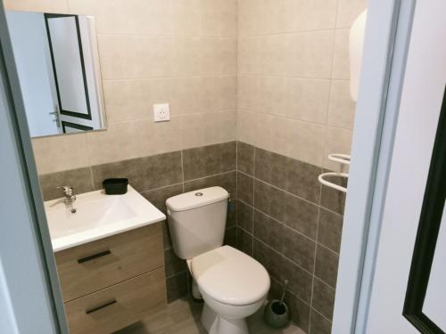 a bathroom with a toilet and a sink at L'escapade in Fontvieille