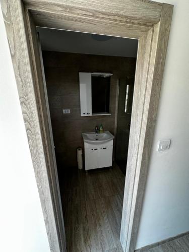 a view of a bathroom with a sink and a mirror at Apartmani Tamaris in Murter