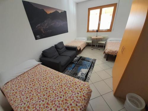 a living room with a couch and a chair at Lunga Via Delle Dolomiti in Calalzo