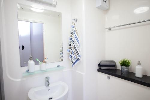 a white bathroom with a sink and a mirror at Unite Students - Sugarhouse Close - Royal Mile in Edinburgh
