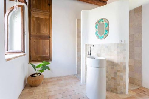 a bathroom with a sink and a potted plant at Luxury Villa with Pool, Stunning Location in San Ginesio