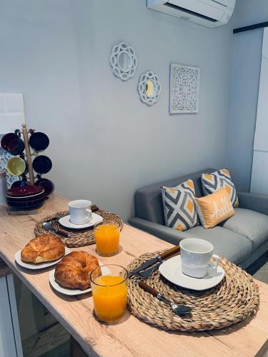 a table with two plates of food and orange juice at Apartamentos Nenufar in Alhama de Aragón