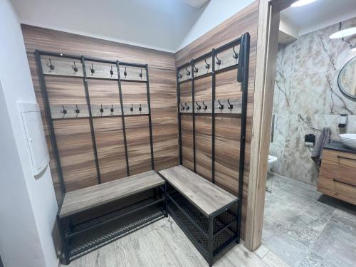 a shower with a bench in a bathroom at Chata Elegant in Bešeňová