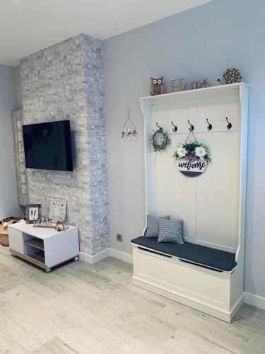a living room with a couch and a tv at Apartamentos Nenufar in Alhama de Aragón