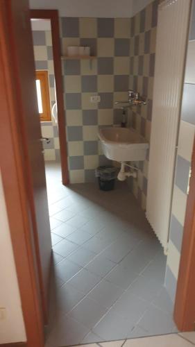 a bathroom with a sink and a toilet at Lunga Via Delle Dolomiti in Calalzo