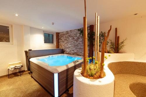 a jacuzzi tub in the middle of a room at Hotel Hofmann in Santa Maddalena in Casies