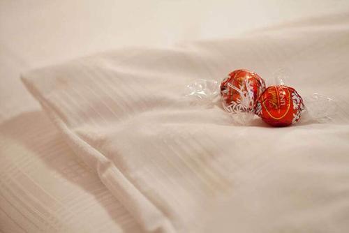 two red candlesticks are sitting on a white sheet at Hotel Hofmann in Santa Maddalena in Casies