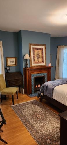 a bedroom with a bed and a fireplace at Oaklawn Inn in Menomonie