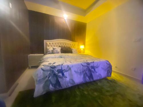 a bedroom with a purple bed in a room at One Bed Executive Apartment in Islamabad