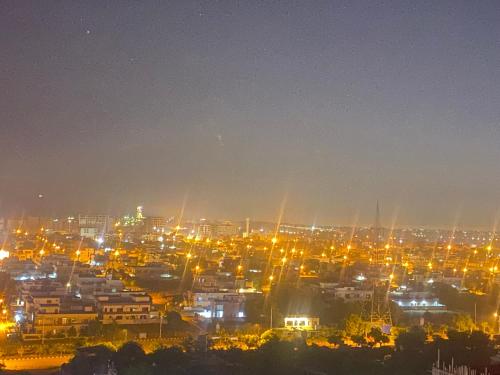 a view of a city at night with lights at One Bed Executive Apartment in Islamabad