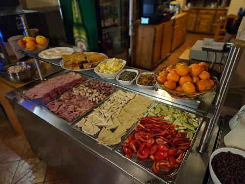a buffet filled with lots of different types of food at Pensiunea Viktoria in Băile Tuşnad
