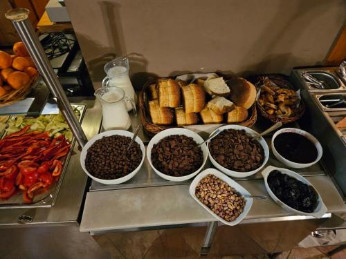 a tray of different types of food on a table at Pensiunea Viktoria in Băile Tuşnad