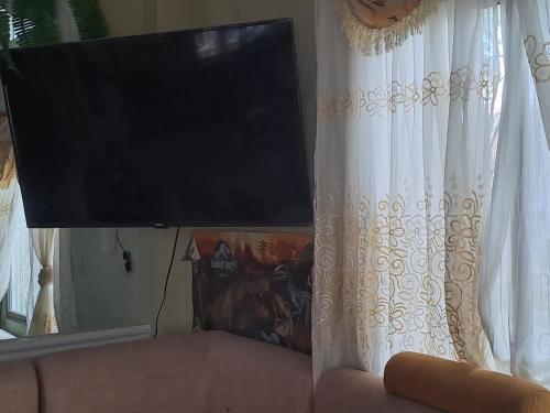 a flat screen tv sitting on top of a curtain at Hospedaje Playa y Arena in Playas