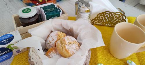a basket of donuts sitting on a table with a cup of coffee at Casa entre Montañas in San Juan
