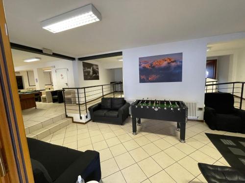 a living room with a table in the middle of it at Lunga Via Delle Dolomiti in Calalzo