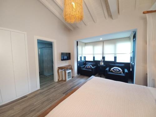 a bedroom with a bed and a chandelier at Chloe hotel Alacati in Alacati