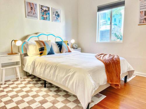 a bedroom with a large white bed with pillows at Groovy Getaway Retro Vibes in North Park, SD in San Diego