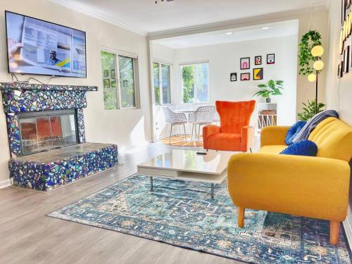 a living room with two yellow chairs and a fireplace at Groovy Getaway Retro Vibes in North Park, SD in San Diego