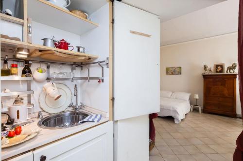 a kitchen with white cabinets and a sink at Vacanze Romane in Rome