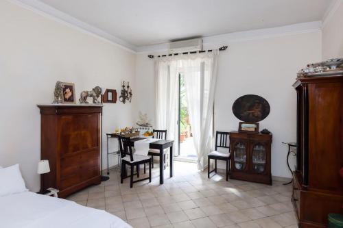 a bedroom with a bed and a dining room with a table at Vacanze Romane in Rome