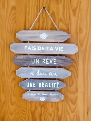 a group of wooden signs hanging on a wall at Appartement Centre port 4 pers Cap d'Agde in Cap d'Agde
