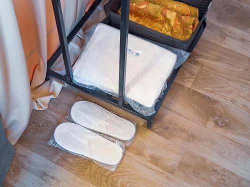 a pair of white shoes sitting on a wooden floor at Starry Domes Desert Camp II in Bidiyah