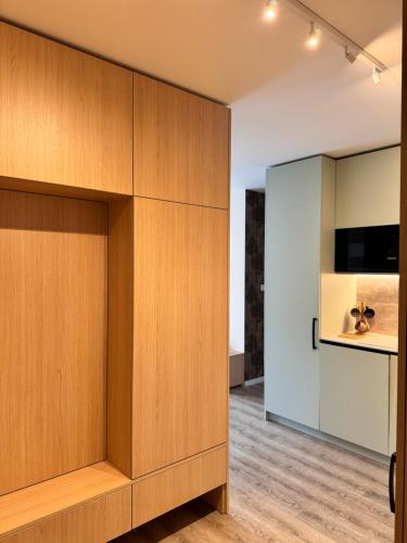 a large wooden cabinet in a room with a kitchen at Smrek Apartments in Oravská Lesná