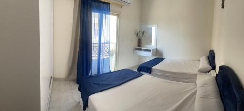 a small bedroom with a bed with a window at Entire apartment$Gorgeous hideout& CoZzy in Hurghada