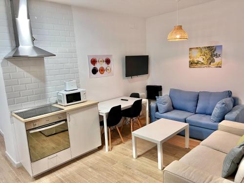 a living room with a couch and a table at Apartamentos La Albariza Jerez Centro in Jerez de la Frontera