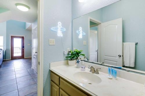 a bathroom with a sink and a large mirror at 'Coastal Retreat: 'Sea Dreams Beach House' in Freeport
