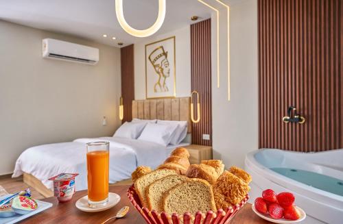 a hotel room with a tray of bread and a tub at Rotana Pyramids View in Cairo