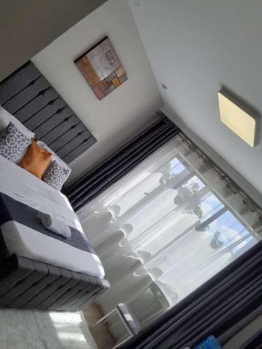 a room with a bed and a glass window at POLAR HOMES in Nairobi